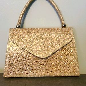 Gold clutch bag with snap closure